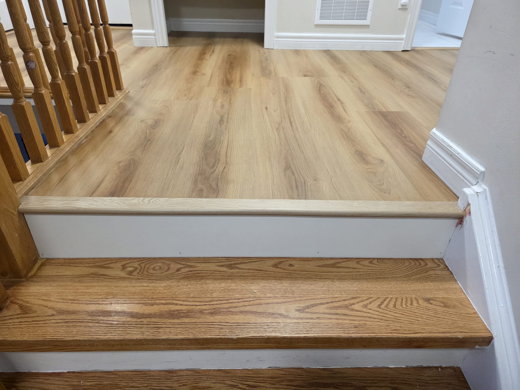 Newly renovated room featuring durable, wood-look vinyl flooring.