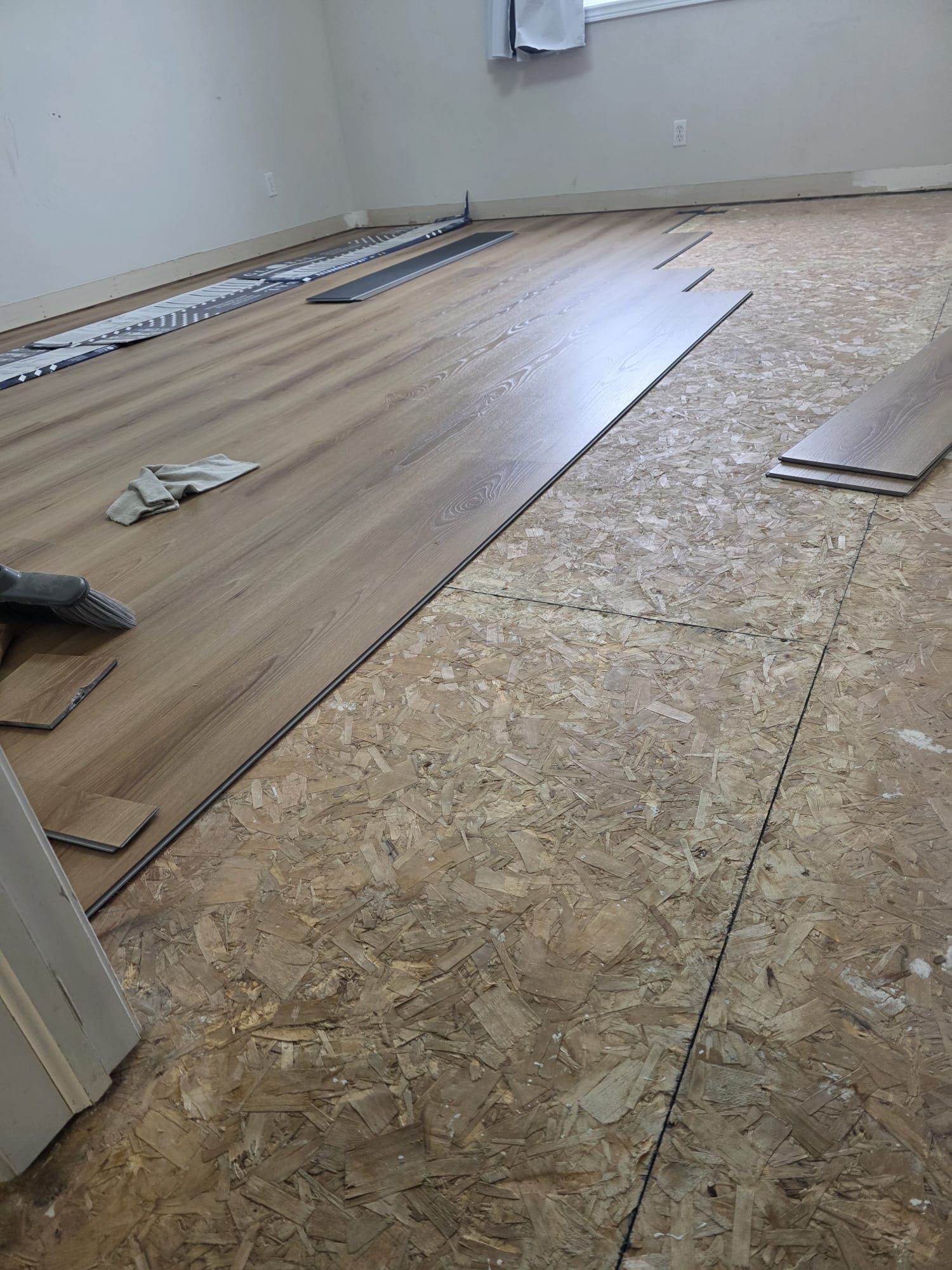 Professional installers laying down durable vinyl floor planks.