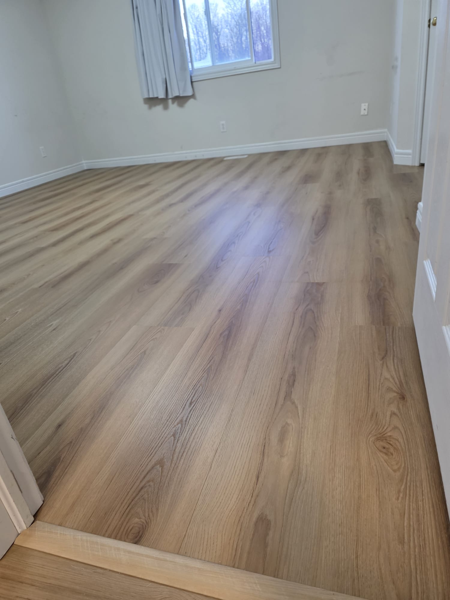 Completed installation showing the modern, seamless finish of vinyl plank flooring.